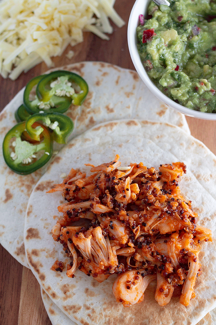 bbq jackfruit tacos served with guacamole, cheese and jalapenos