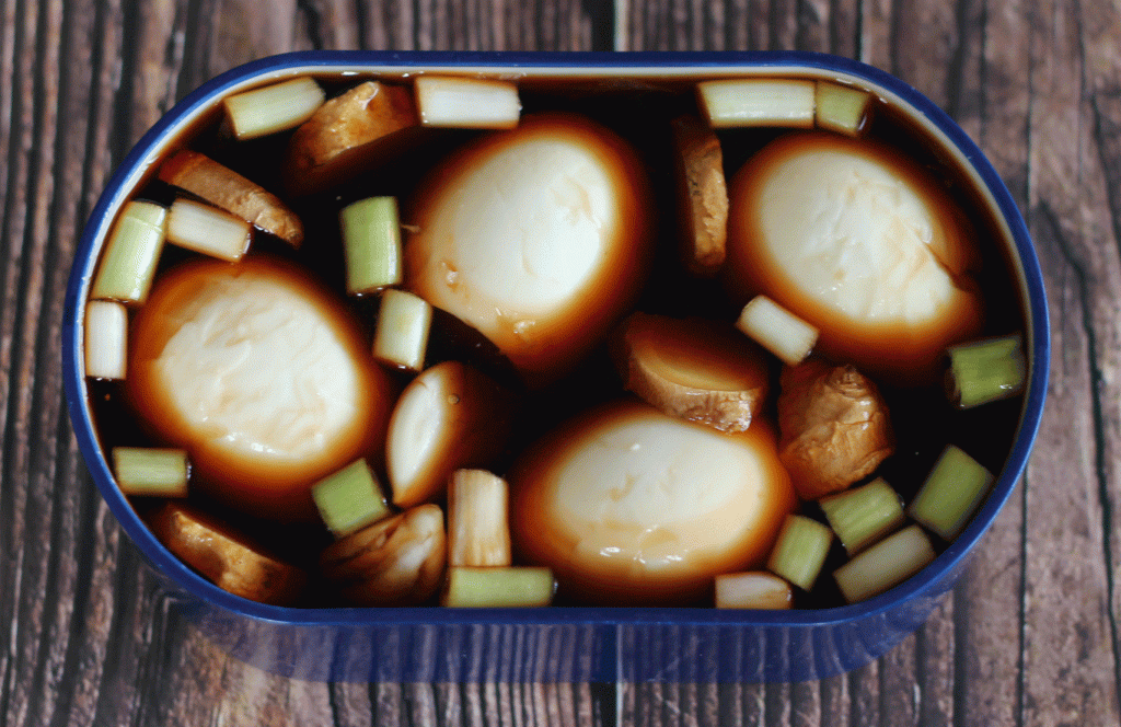cooked, peeled soy marinated ramen eggs in marinade