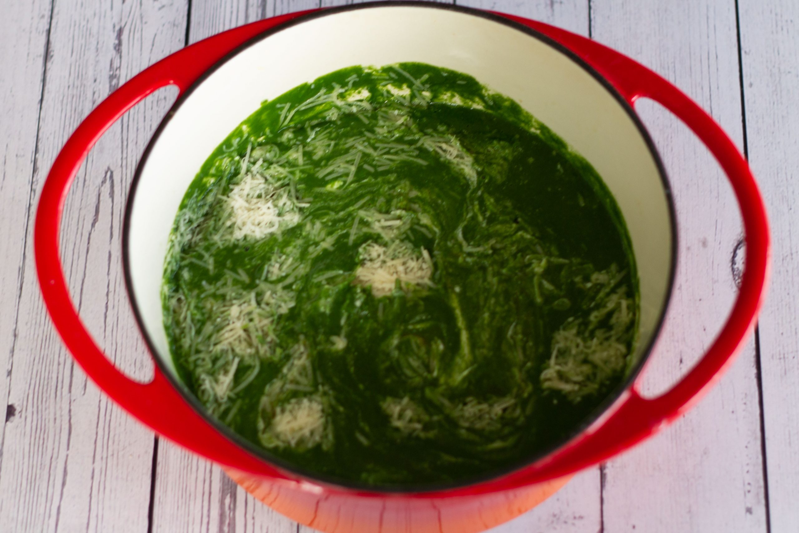 green soup with lemon juice, parmesan and cottage cheese added