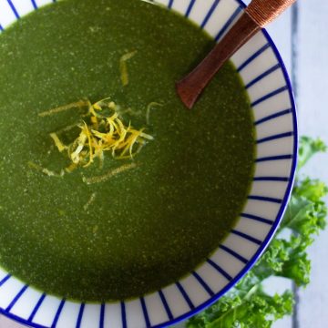 bowl of green soup topped with lemon zest