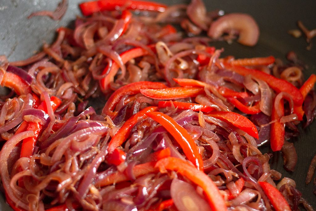 caramelised onion and red pepper in a frying pan