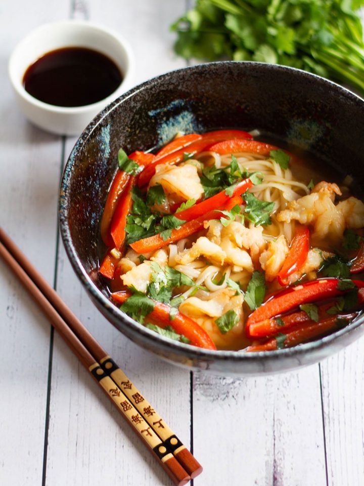 A bowl of prawn pho and chopsticks
