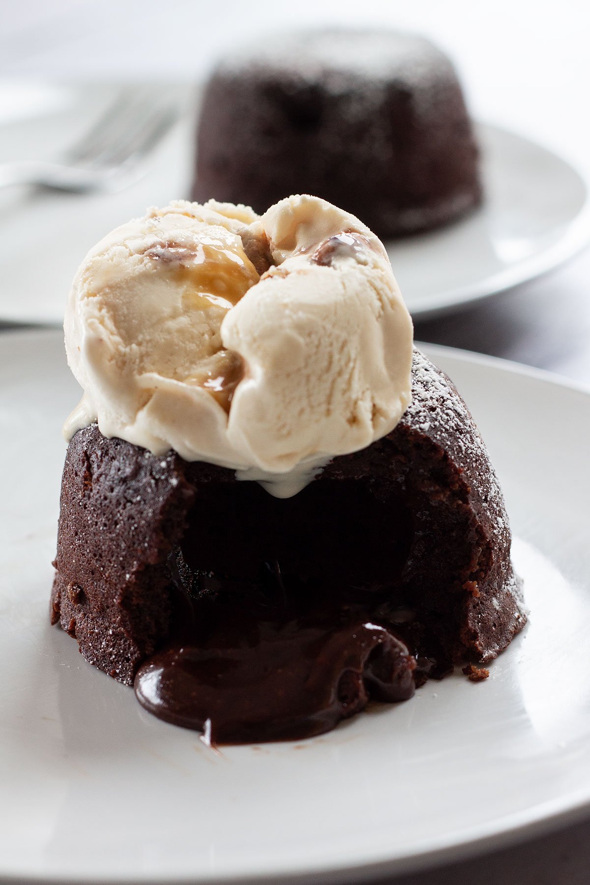 A chocolate lava cake with ice cream.