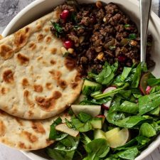 bowl of lamb mince with flatbread and salad