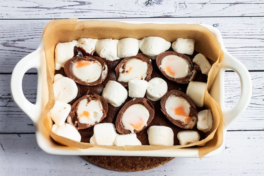 Brownie base with Cream Eggs and marshmallows on top.