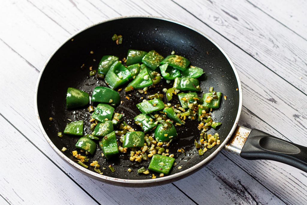 Green chilli, ginger and green pepper in frying pan