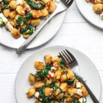 Servings of Fried Gnocchi With Feta, Spinach and Pine Nuts