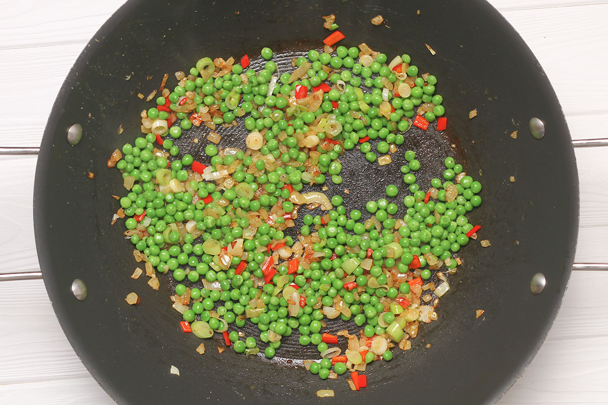 Frying the aromatics and peas