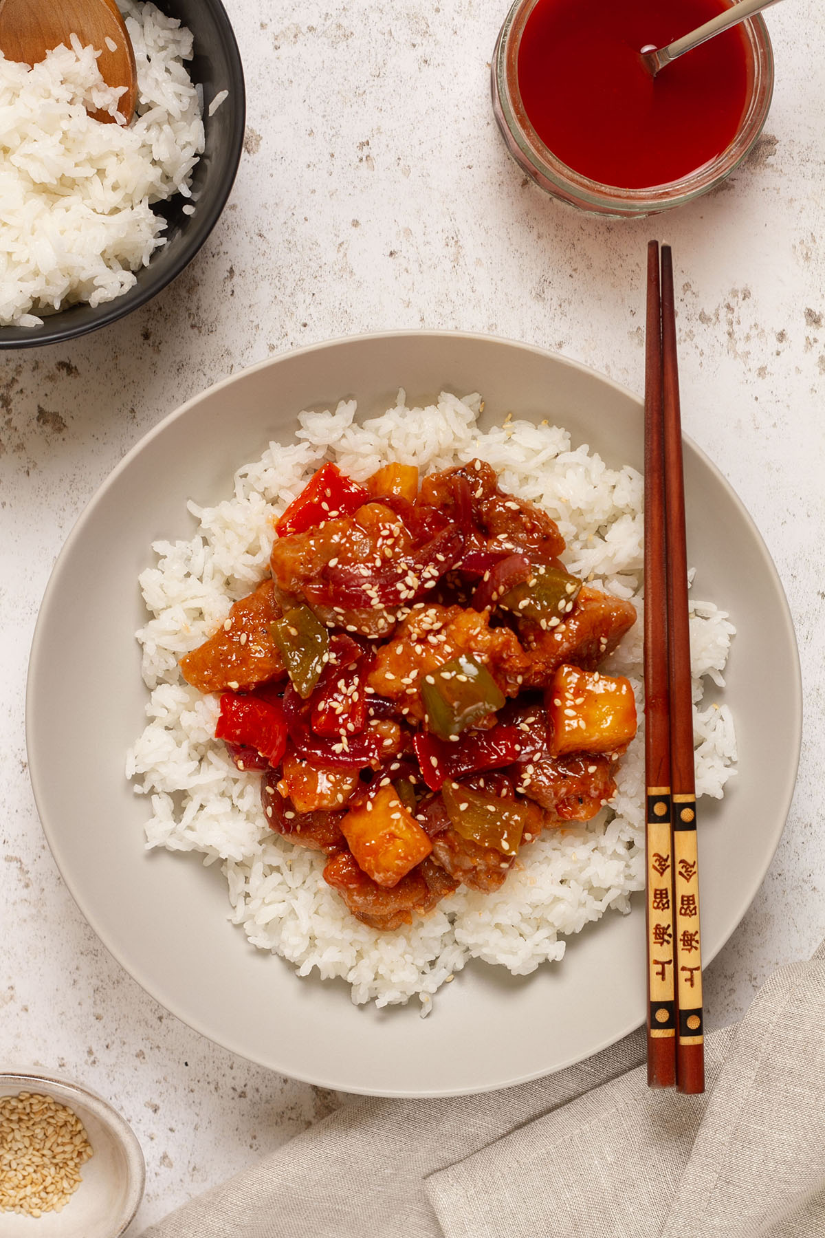 Sweet and Sour Chicken in a bowl with white rice.