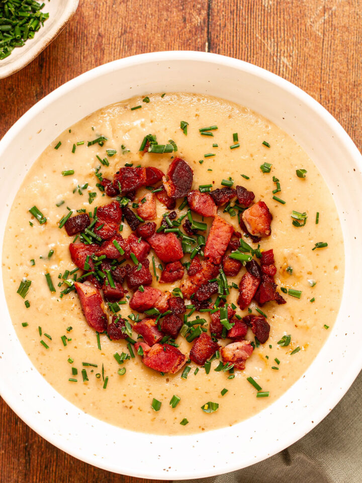 A bowl of potato soup topped with bacon