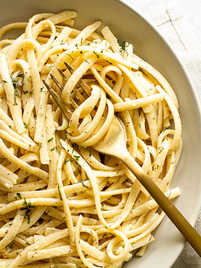 A bowl of pasta with creamy white wine sauce.
