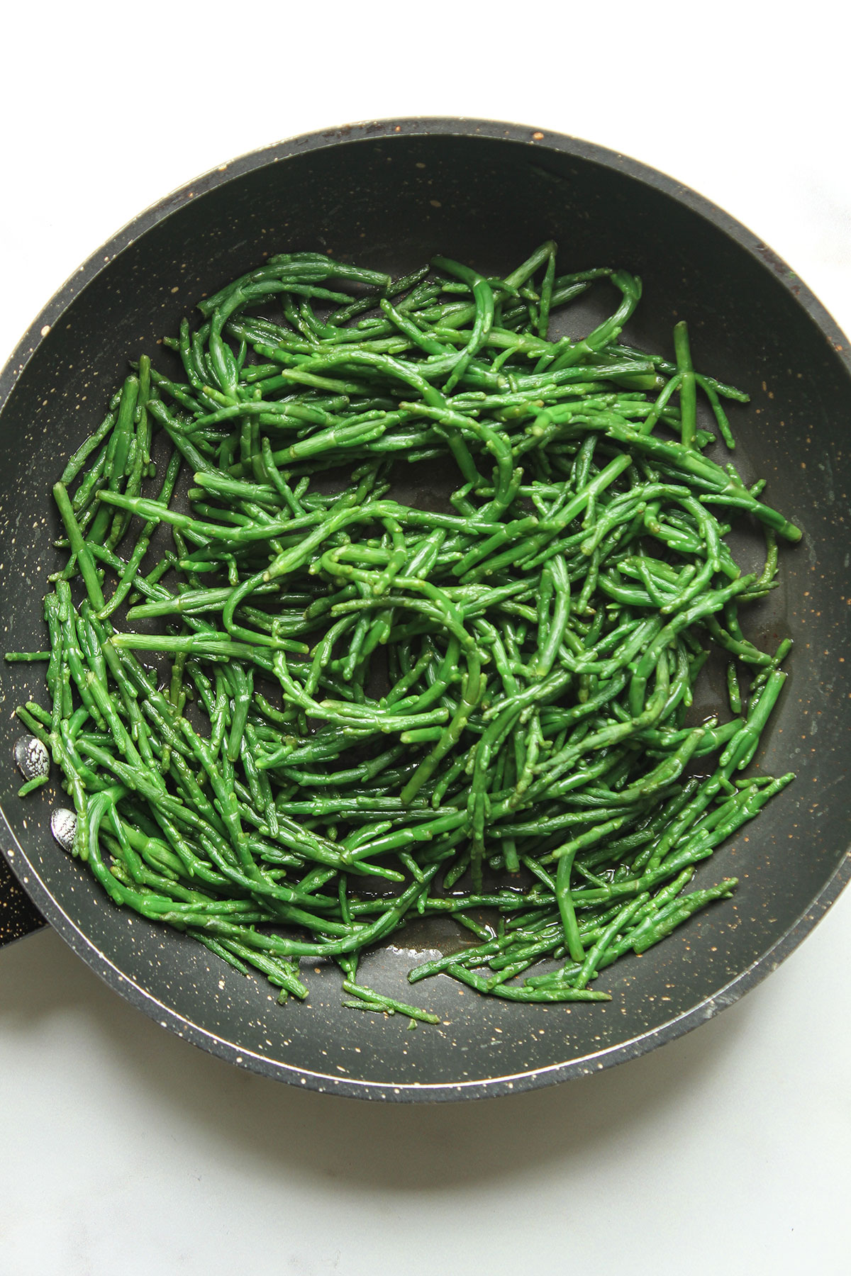 A pan containing samphire cooking for a few minutes until tender.