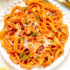 A bowl of Mascarpone Tomato Pasta on a white background.