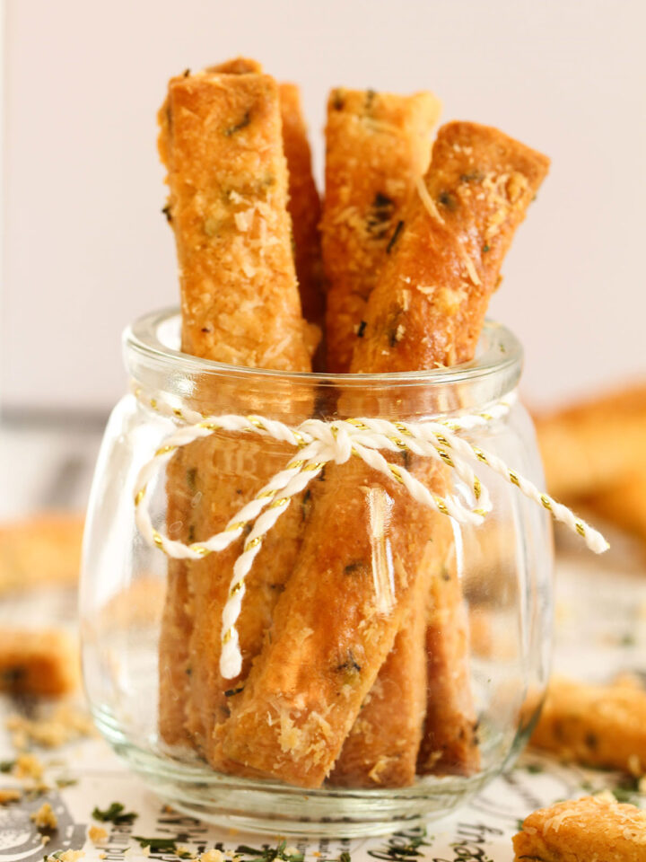 Cheese Straws standing in a glass jar.