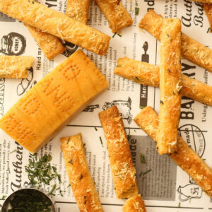 Cheese Straws laid out on a newspaper background.