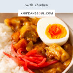 A serving of Japanese Curry with chicken, topped with pickled red ginger and hard boiled egg.