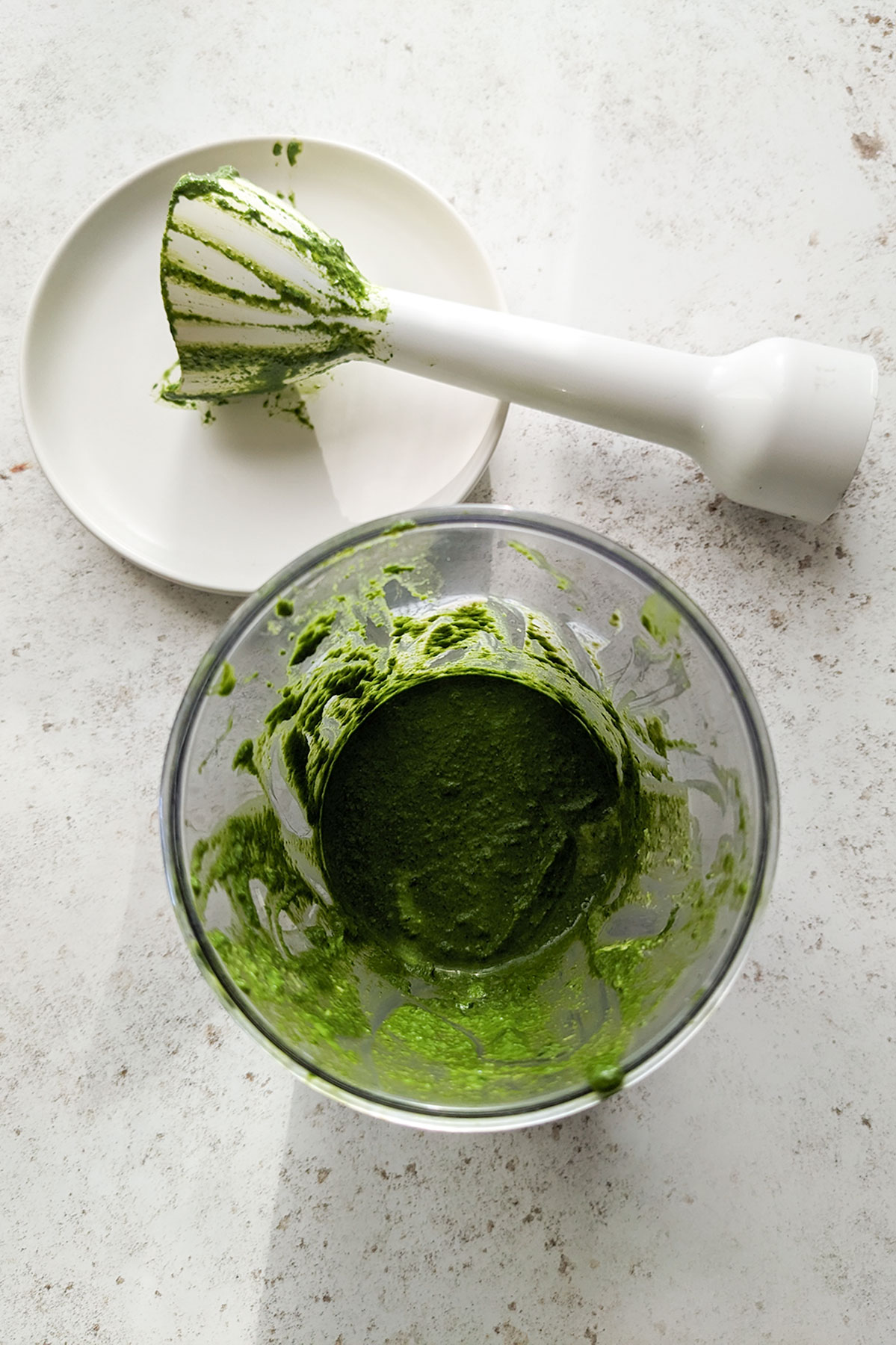 Blitzing the spinach, basil, Parmesan, cream and lemon in a glass bowl until smooth.
