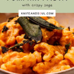 A bowl of Roast Pumpkin Pasta topped with crispy sage leaves.