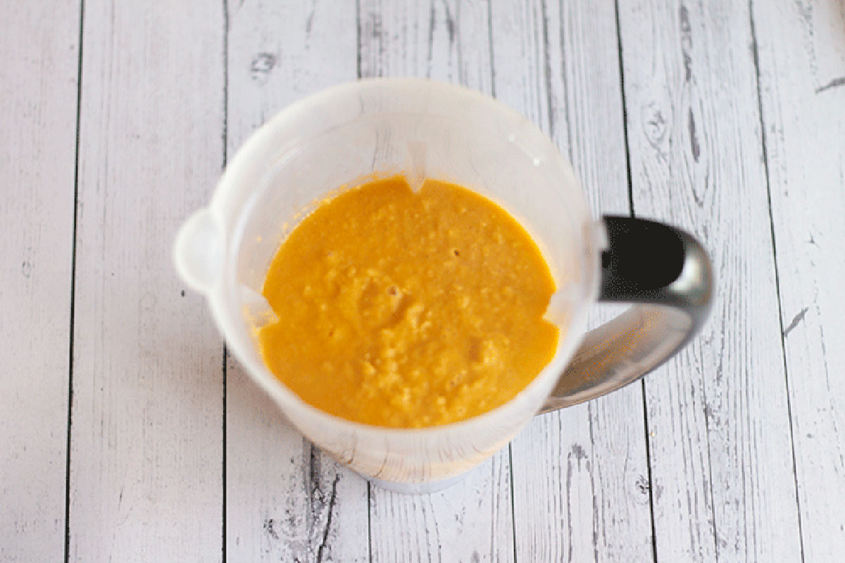 corn soup in a blender on a white background