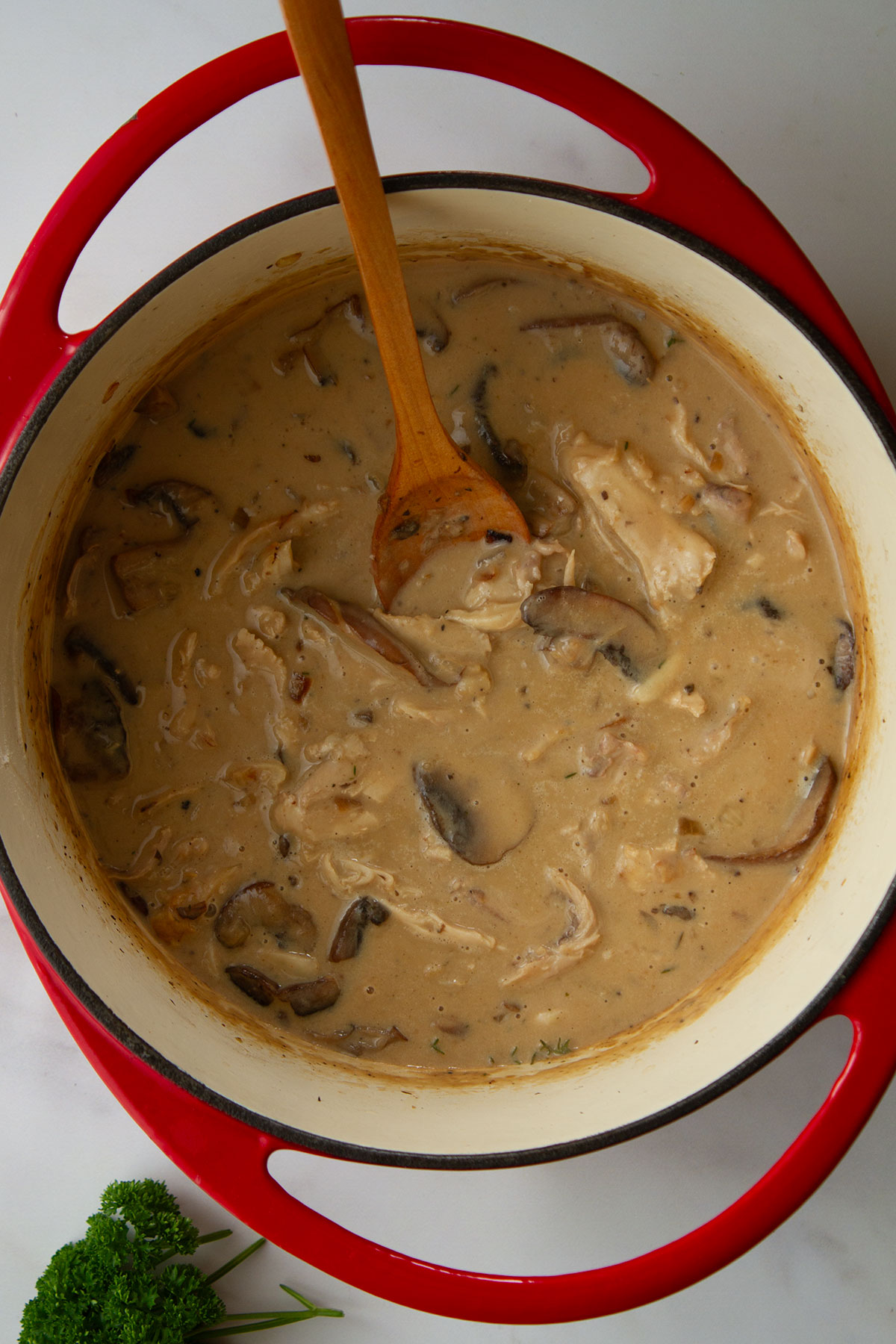 A dutch oven with cream and cooked turkey added.