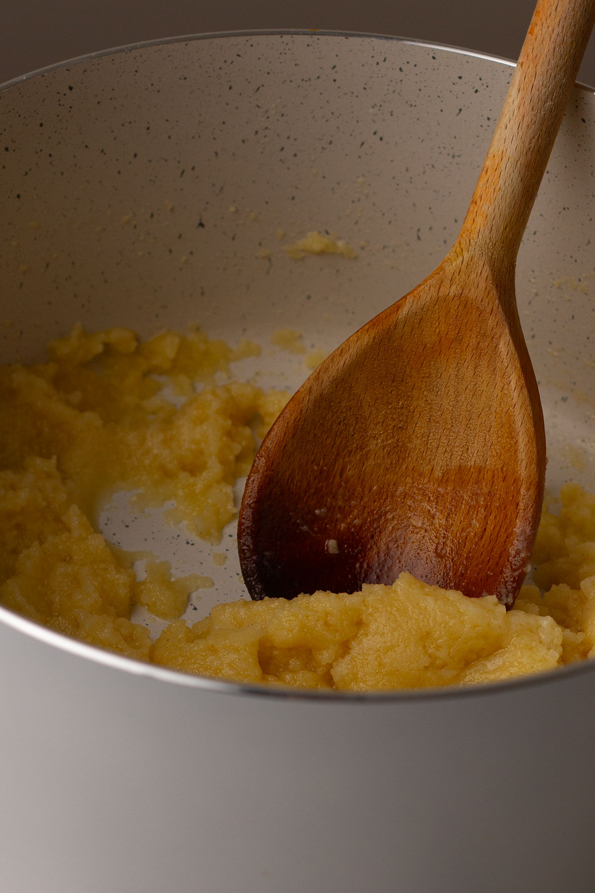 Melting the butter and adding flour and mixing with a wooden spoon to form a smooth paste.