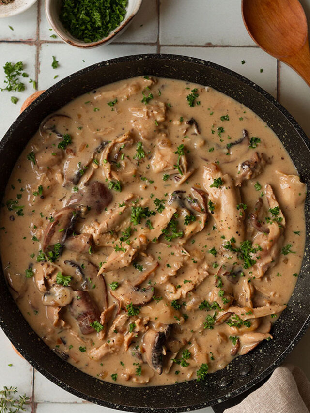turkey fricasse sauce in a pan on a white tiled background