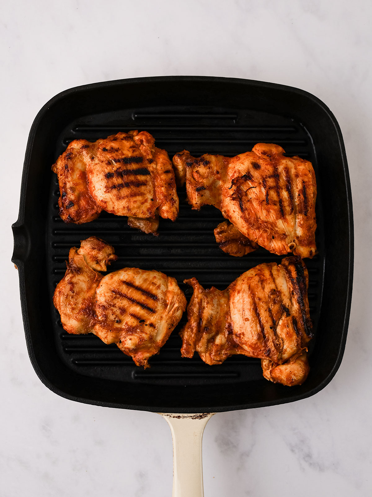 Grilling the marinated chicken on medium-high heat for 6-8 minutes per side until cooked through and slightly charred.